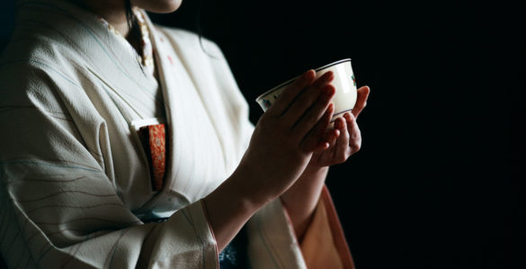 Japanese tea ceremony, a woman in kimono holding a tea cup