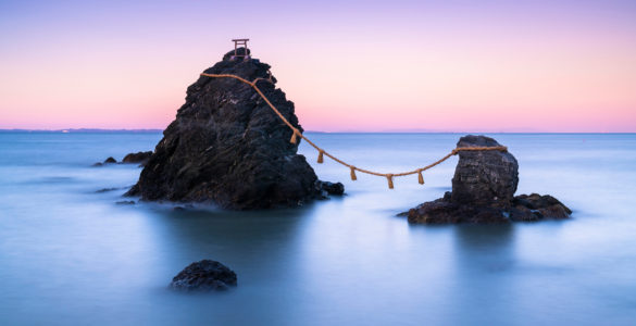 The wedded rocks (Meoto Iwa) in Ise, Japan on sunset. The larger of the two rocks represents the husband and the smaller one represents the wife.