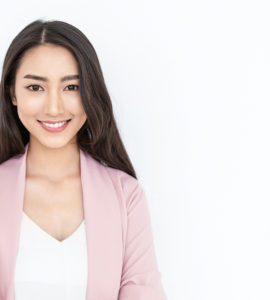 portrait of smiling confident woman in a pink jacket