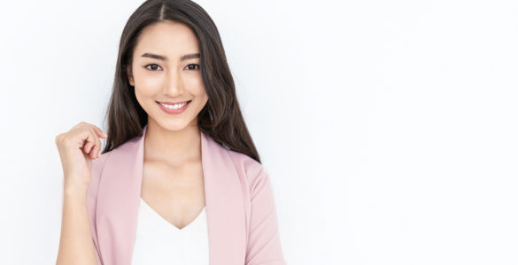 portrait of smiling confident woman in a pink jacket